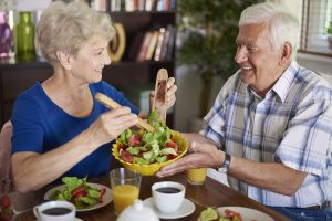 seniors enjoying a healthy breakfast on the summer day