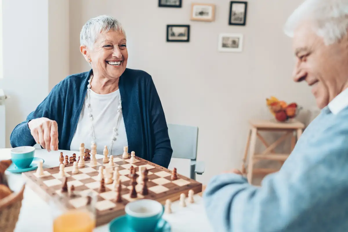 a senior couple playing chess